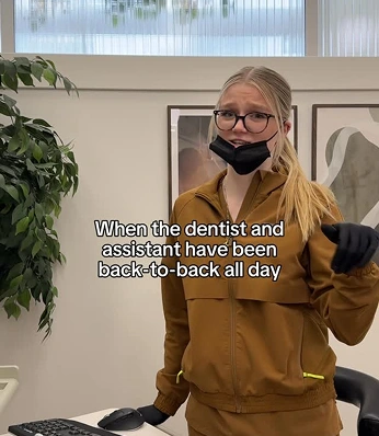 Dental assistant wearing a mask and gloves standing in the clinic after a busy day, with text overlay about back-to-back appointments.