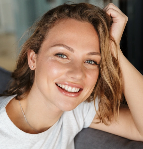 Cosmetic dentistry patient showing off a beautiful smile transformation at Rō Dental Studio in Calgary