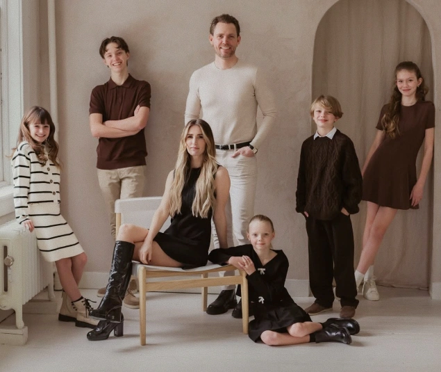 Co-founders Taylor and Dr. Ben posing with a group of children for the Rō Dental Studio Founders' Story